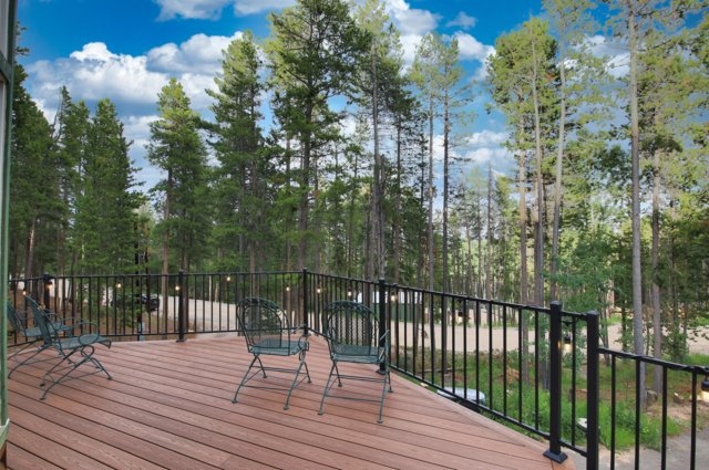 Wraparound deck with seating overlooking the pine forest